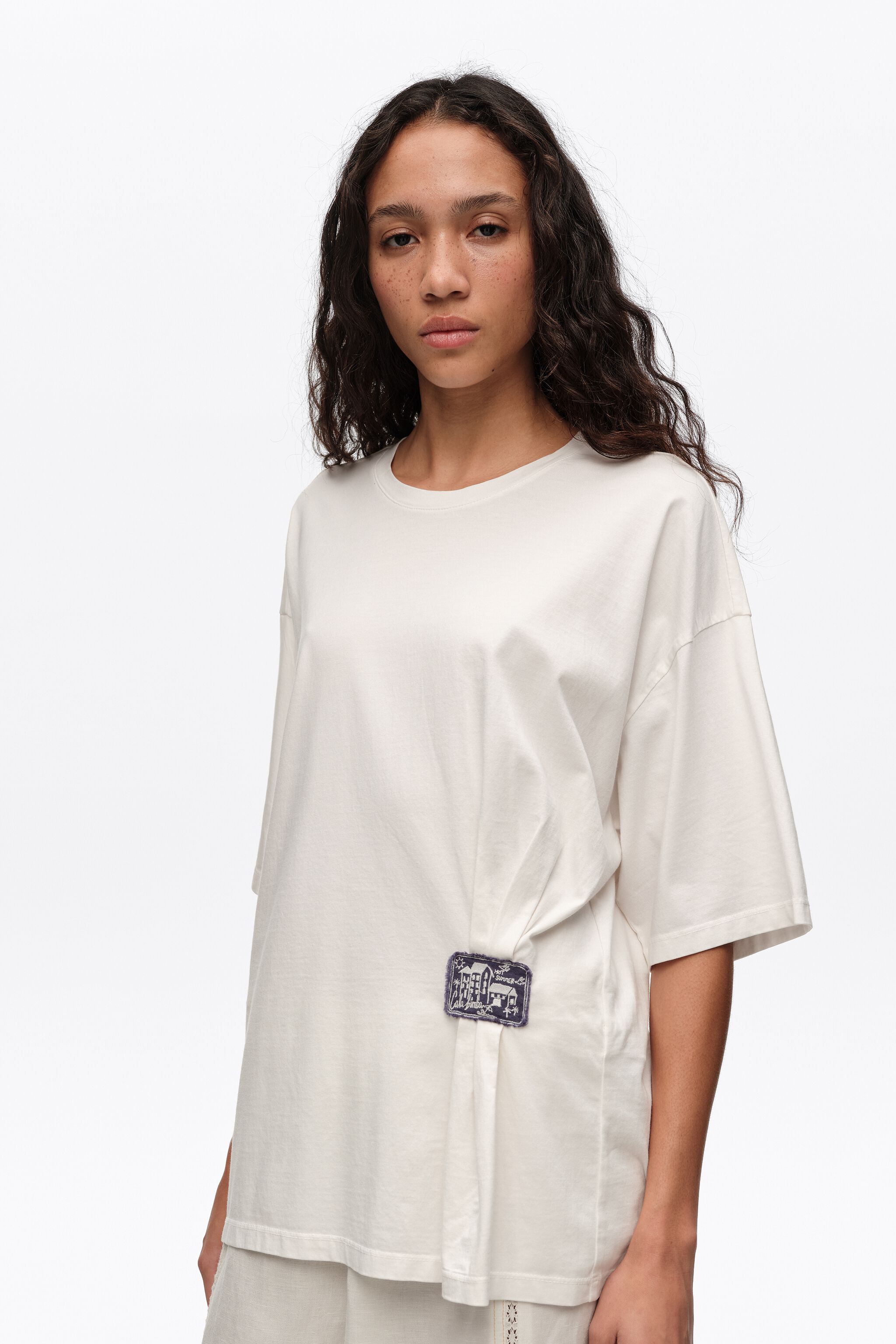 Camiseta blanca con volantes y etiqueta personalizada