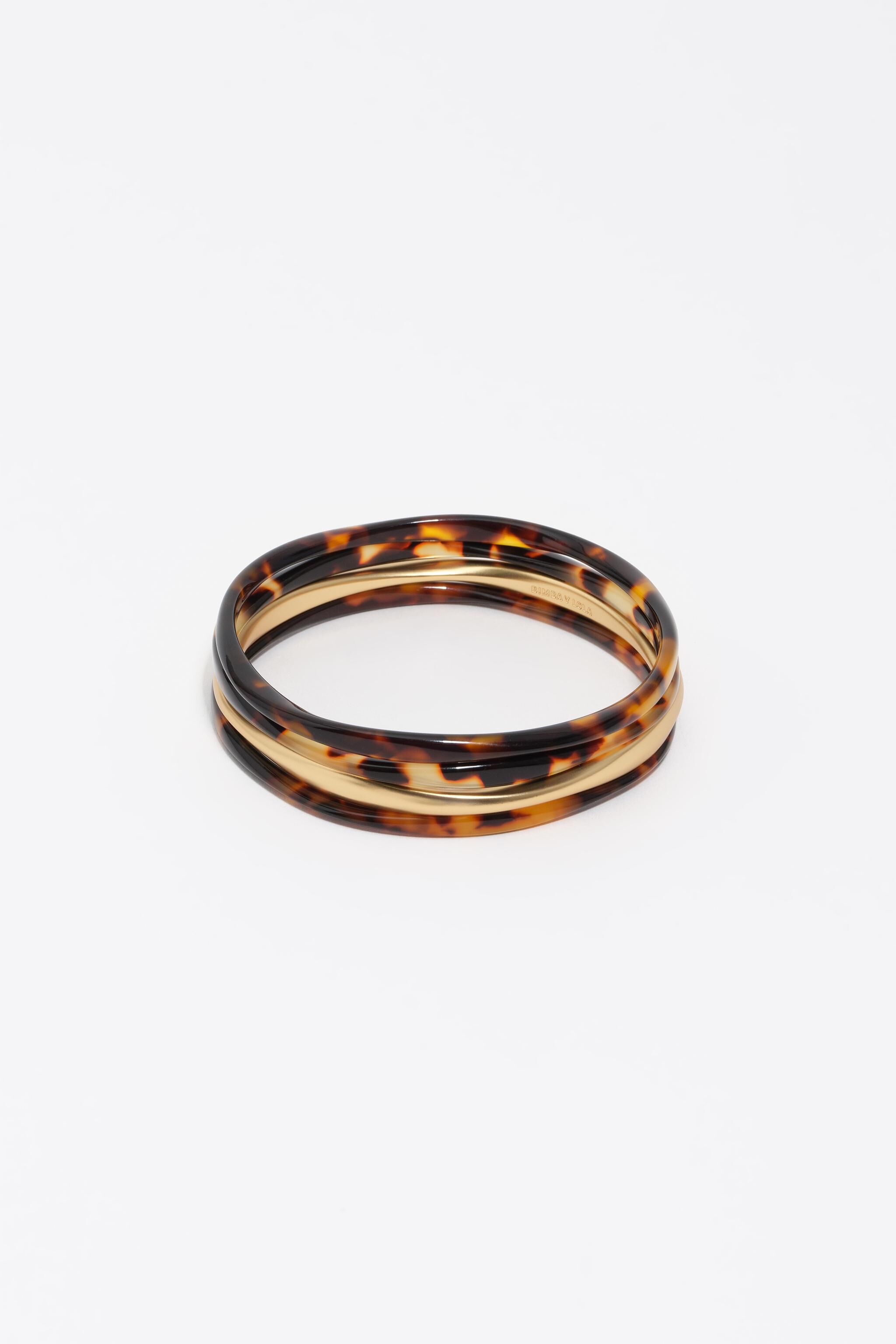 Conjunto de 4 pulseras con efecto marfil y acabado dorado mate